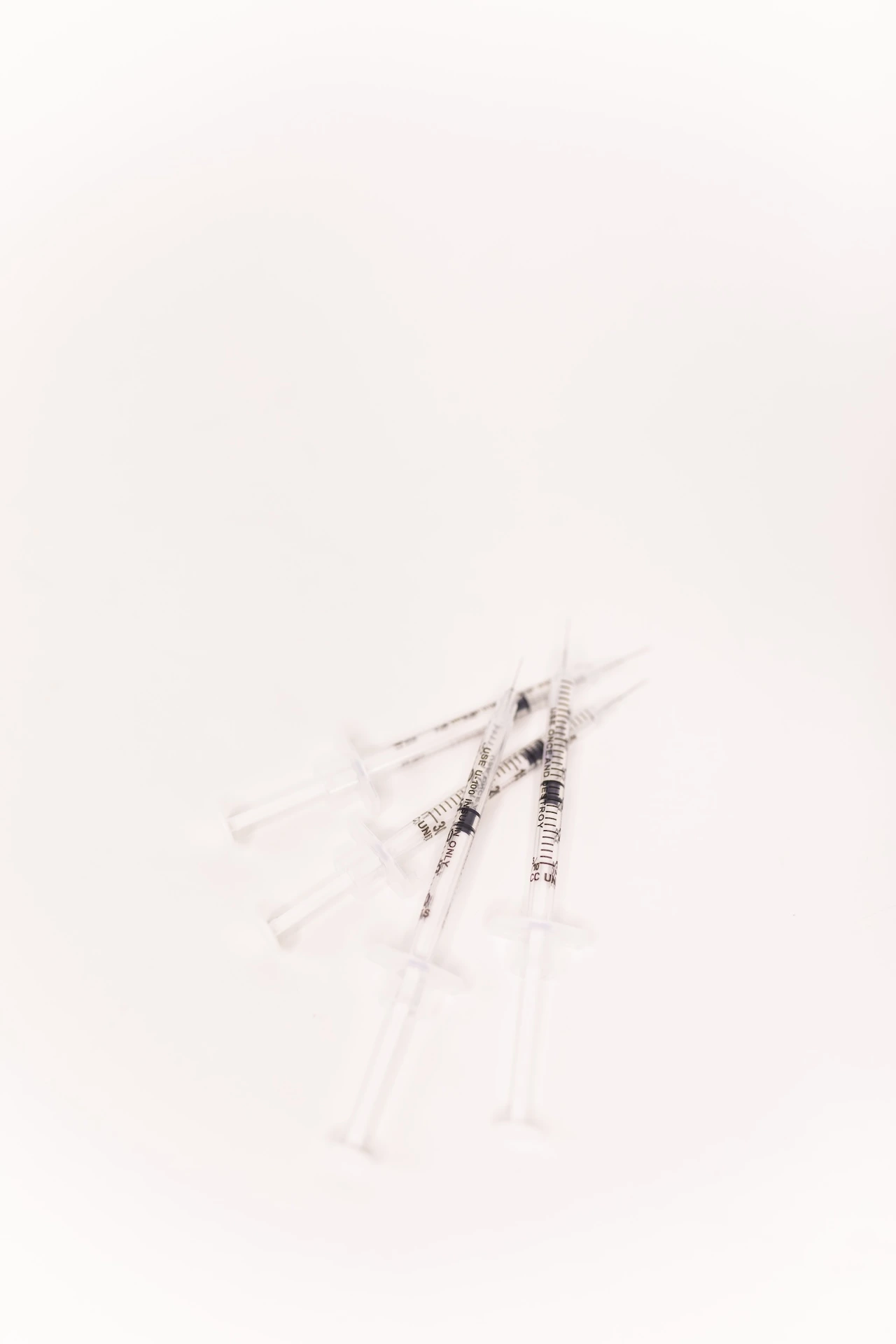 a group of syringes on a white background