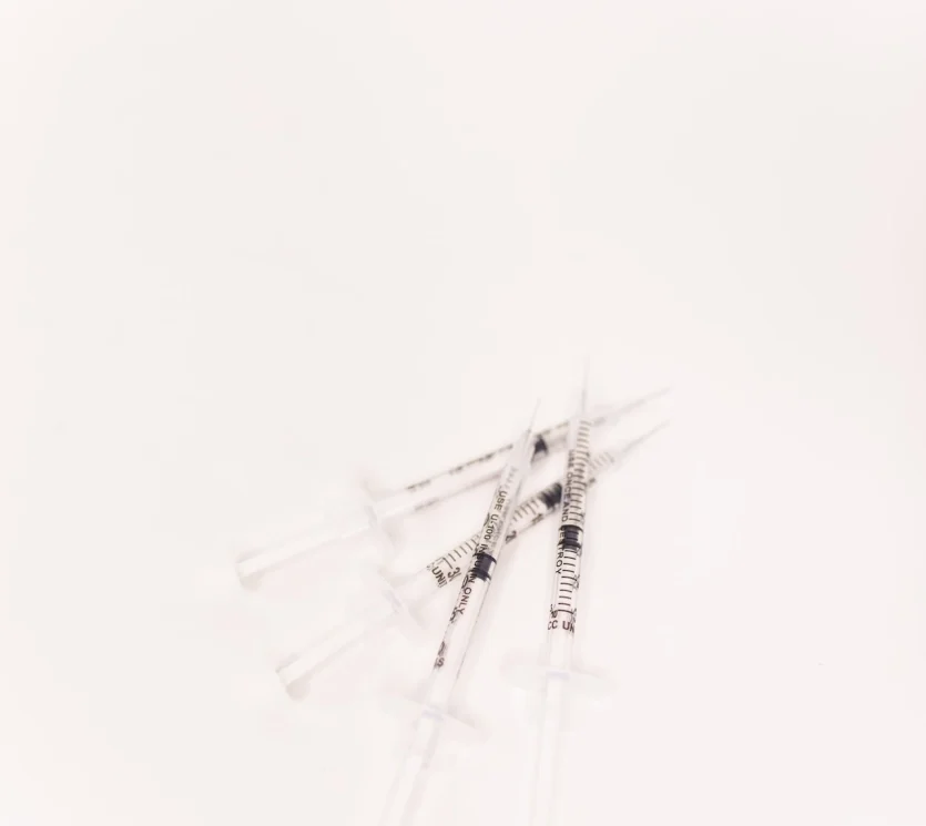 a group of syringes on a white background