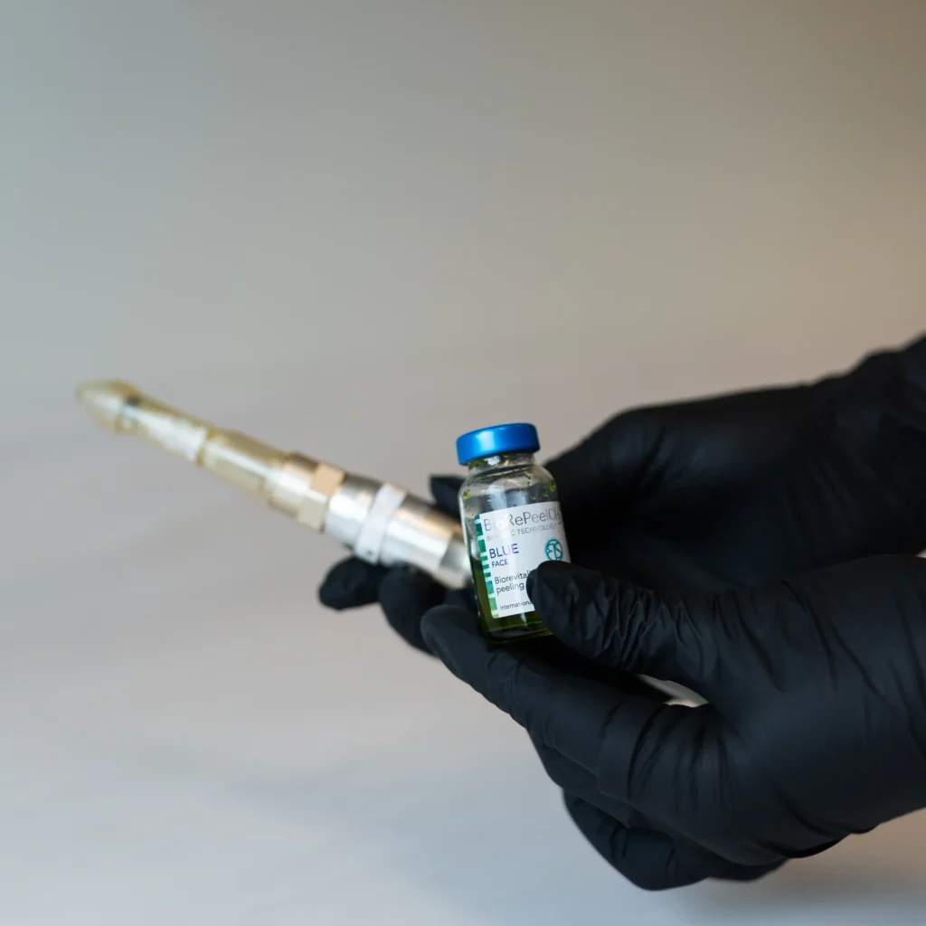 a person holding a small bottle of liquid, Chemical Peels in Brentwood, TN